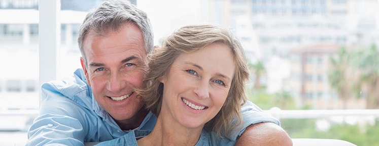 husband and wife smiling