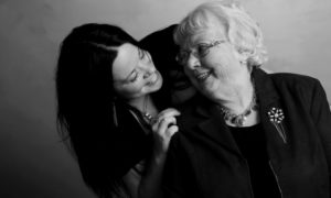 granddaughter and grandmother smile at each other knowing genetics plays a role in oral health