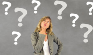 woman thinking surrounded by question marks