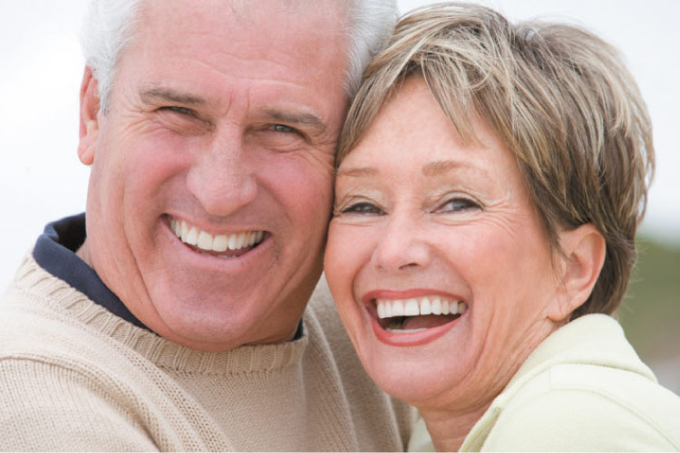 senior couple smiling after learning about nXtsmile implants