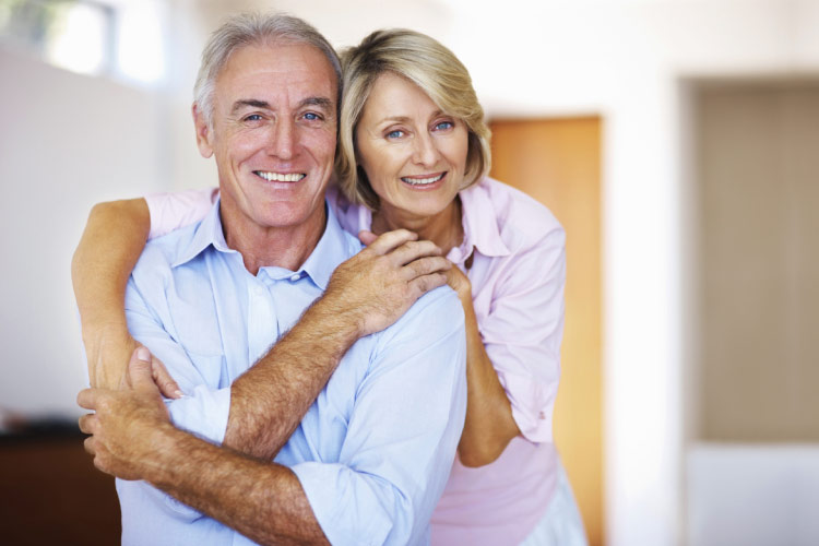 senior couple hug and smile after learning about zircteeth implants