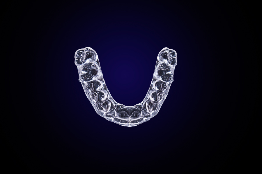 Aerial view of a clear aligners for kids on a navy blue background