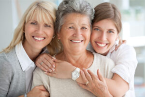 3 generations of women embrace: a mom, gramma, and granddaughter