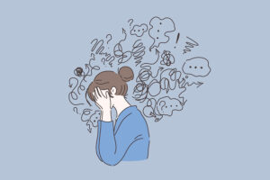 Illustration of a brunette woman in a blue blouse with her head in her hands surrounded by a squiggly cloud of dental anxiety and fear