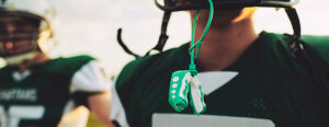 mouthguard hanging from a football player's helmet
