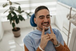 man holding clear aligners for clear aligner therapy