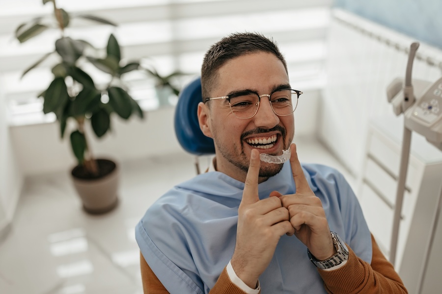 man holding clear aligners for clear aligner therapy